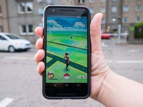ABERDEEN UNITED KINGDOM - JULY 15 2016: People playing "Pokemon GO" the hit augmented reality smart phone app while trying to find Pokemon on July 15 2016 in Aberdeen United Kingdom.