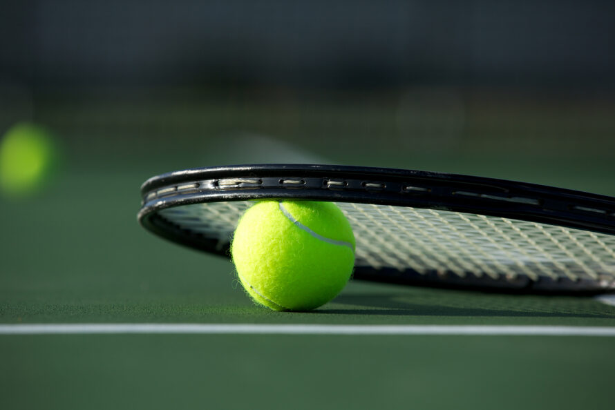 Tennis Ball and Racket on the Court with room for copy nadal